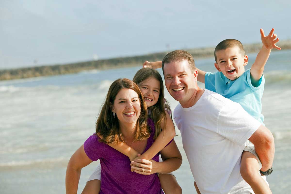 a smiling family on beach