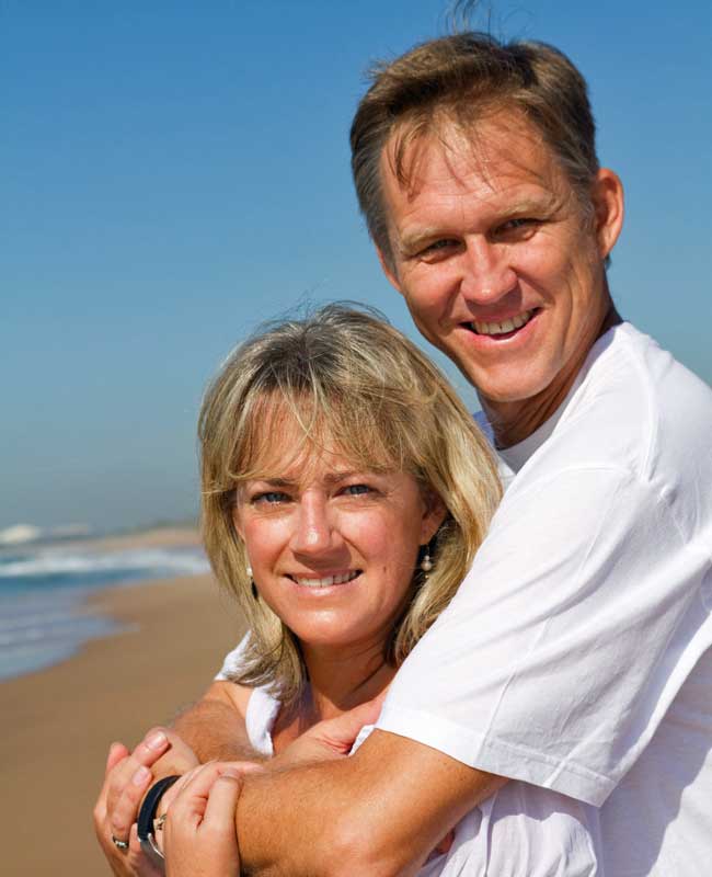 happy couple on beach2 happy couple smiling on a beach
